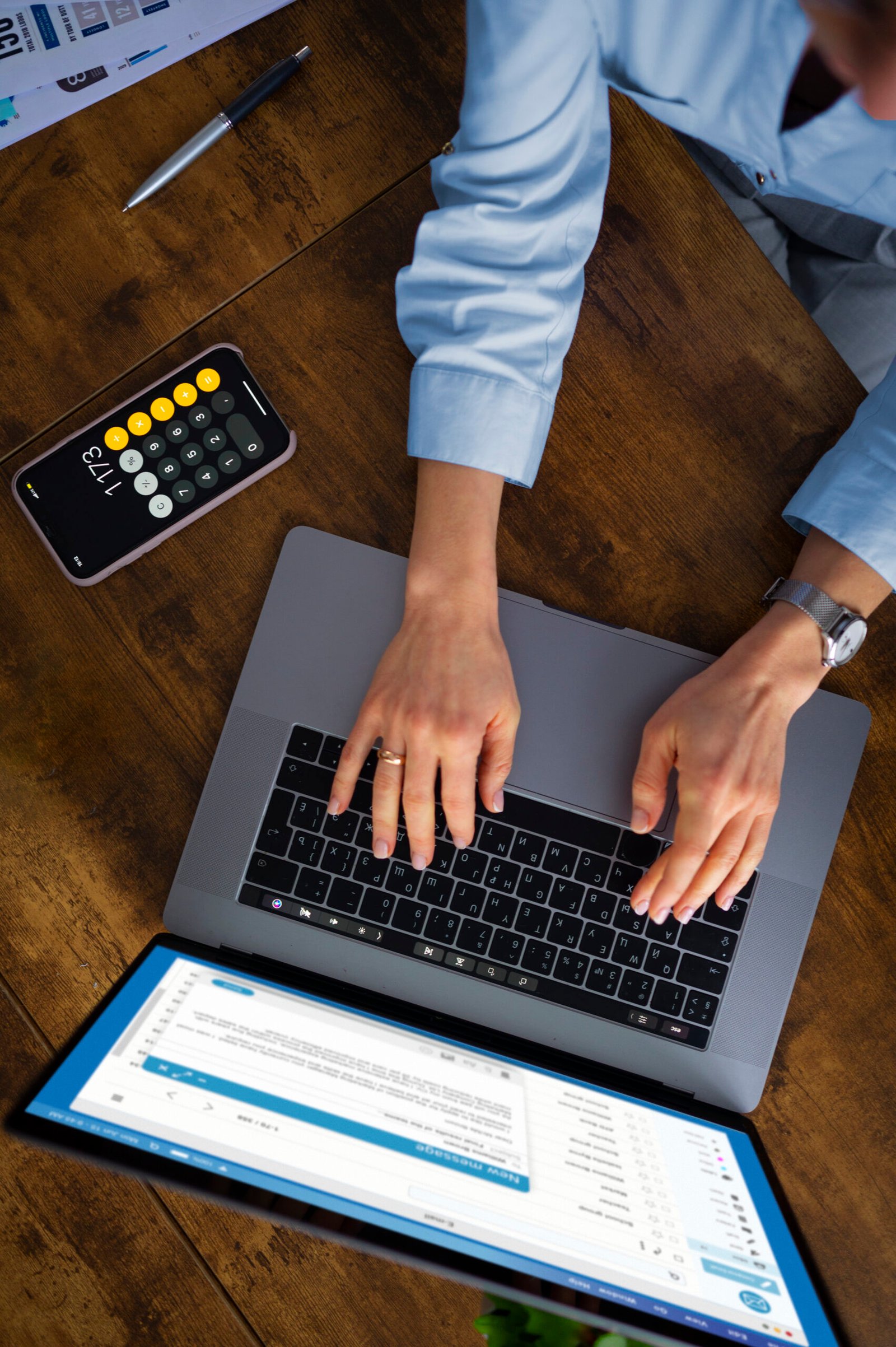 Woman typing on a laptop managing billing and revenue cycle tasks